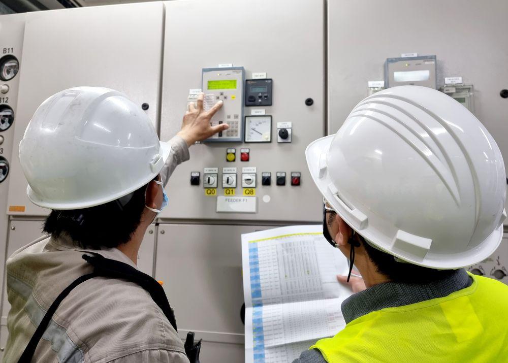 two electrical engineer rechecking the protection relay settings