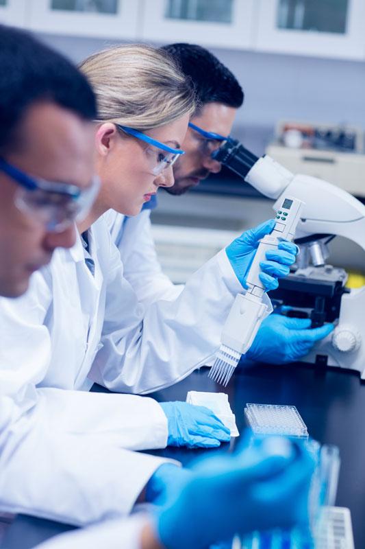 Technicians drawing samples at a lab